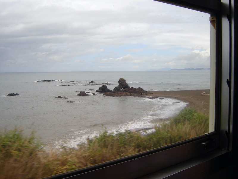 looking out a train window at the Japan Sea
