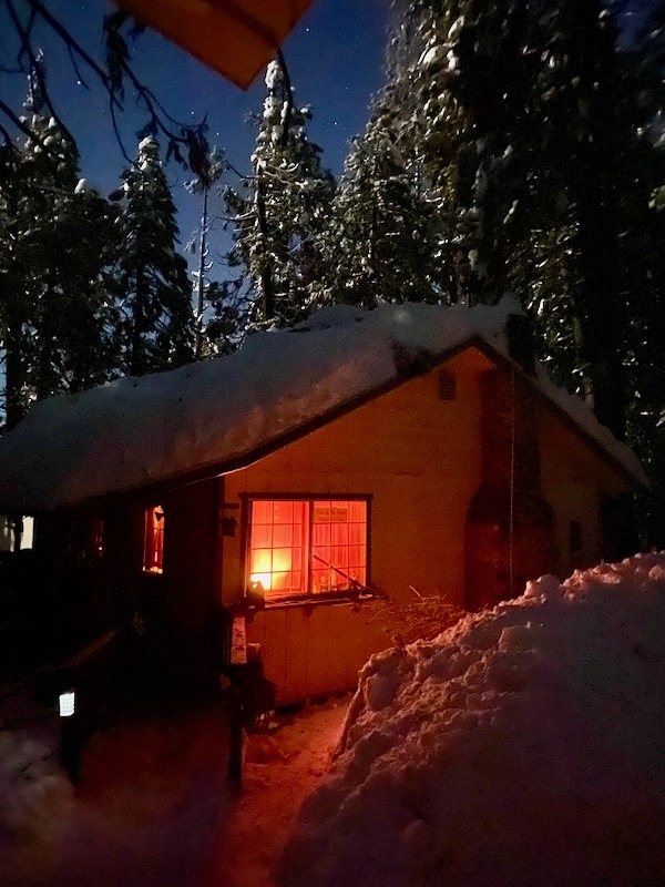 House light and moonlight on snow