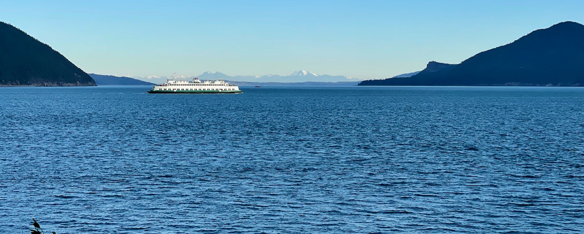 Ferry boat with mountains in view beyond