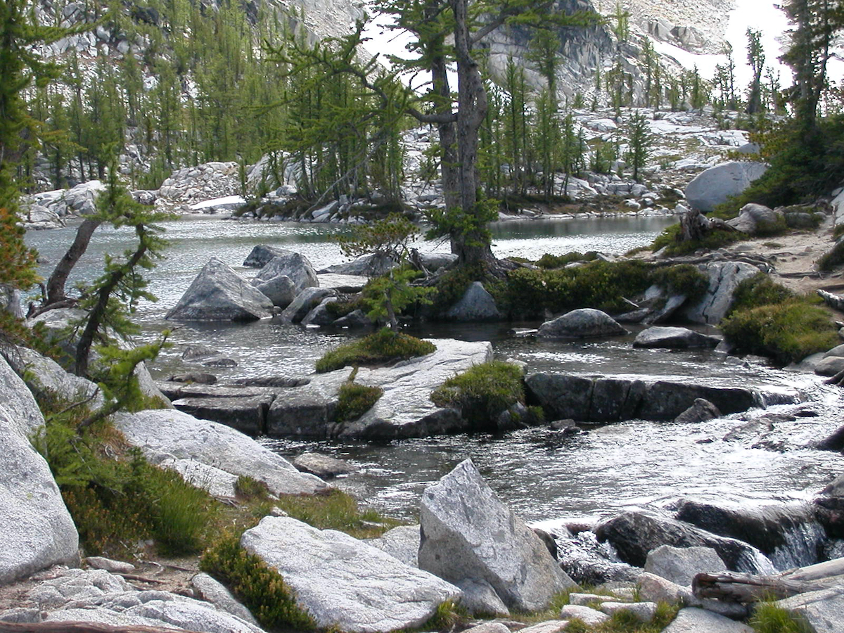 a stream through rocks from a lake