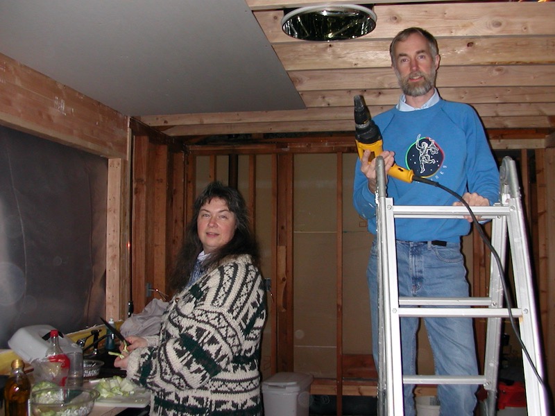 Melanie cooking, Larry adding drywall