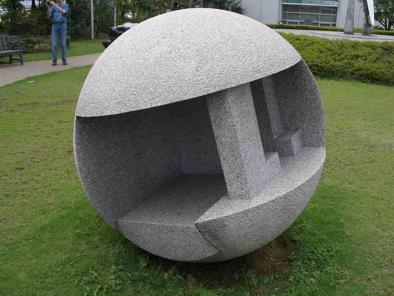 a stone sphere with square cut-outs