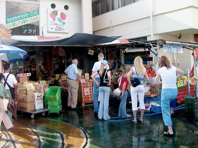 standing in front of fresh produce market