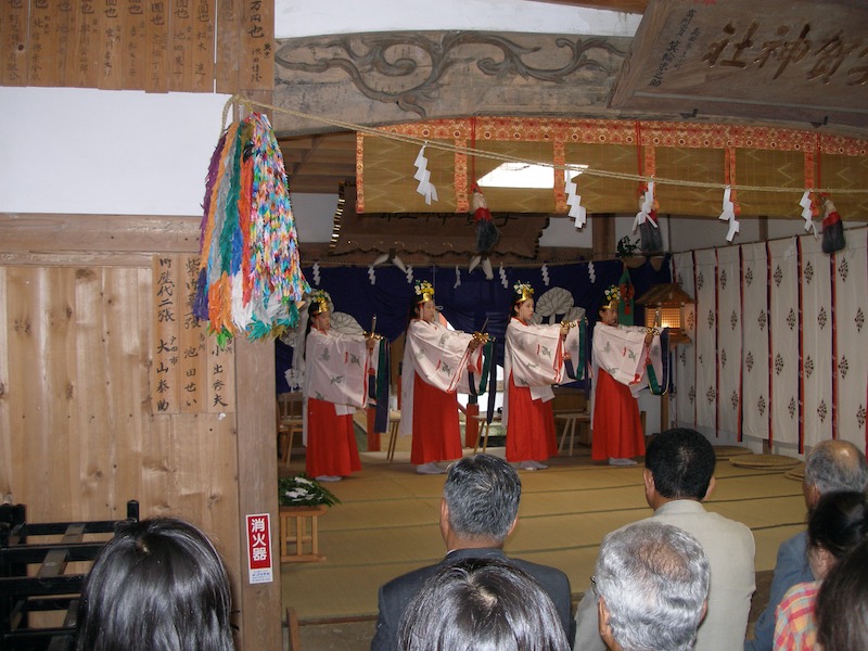 four young girls dancing on raised tatami