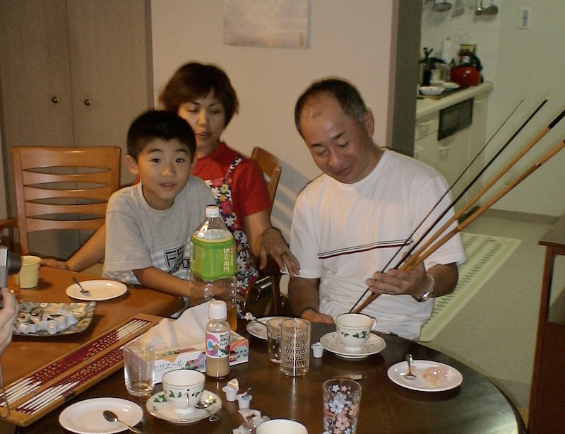 holding bamboo fishing poles