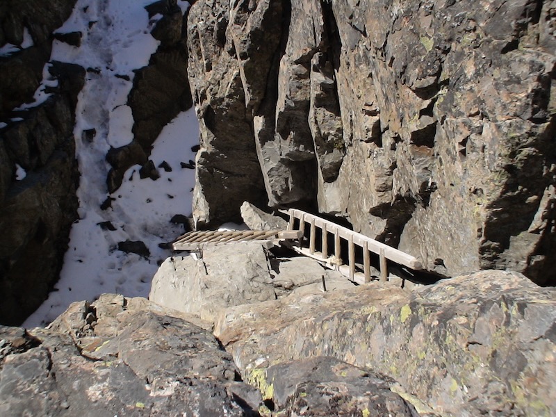 looking straight down on wooden ladders