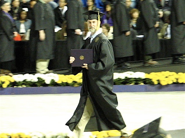 Larry walking with diploma