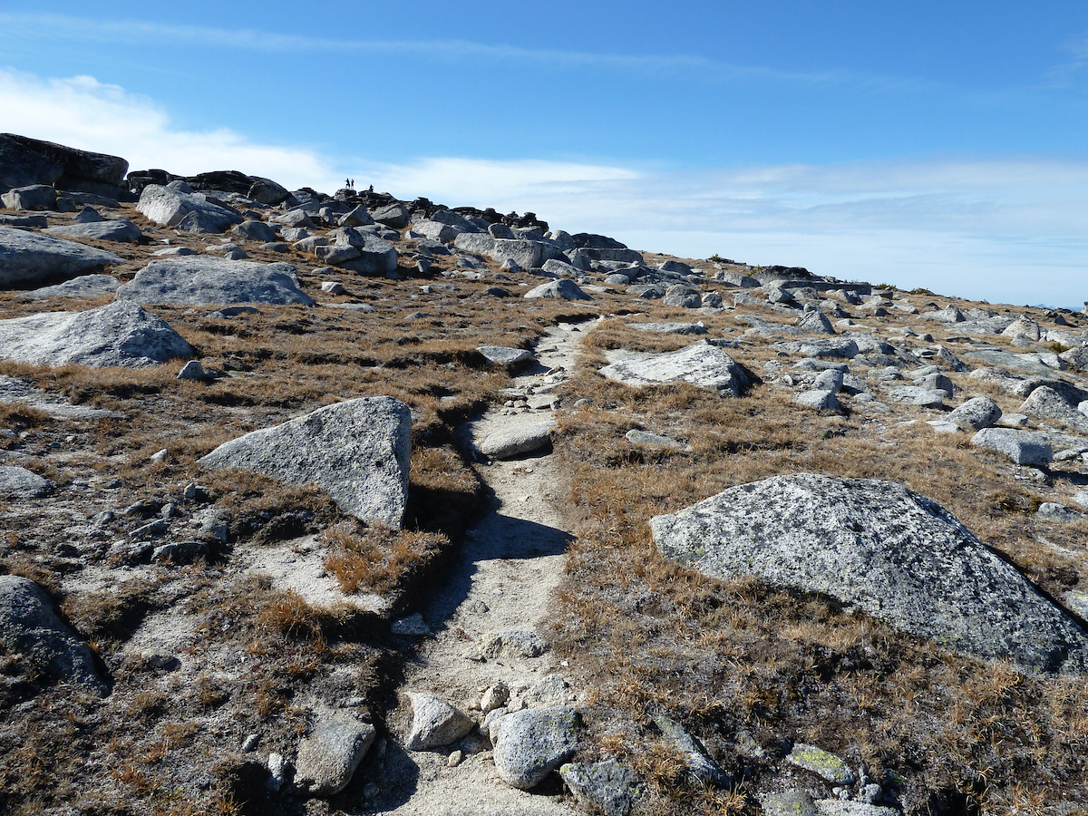 trail up grassed slope and rocks