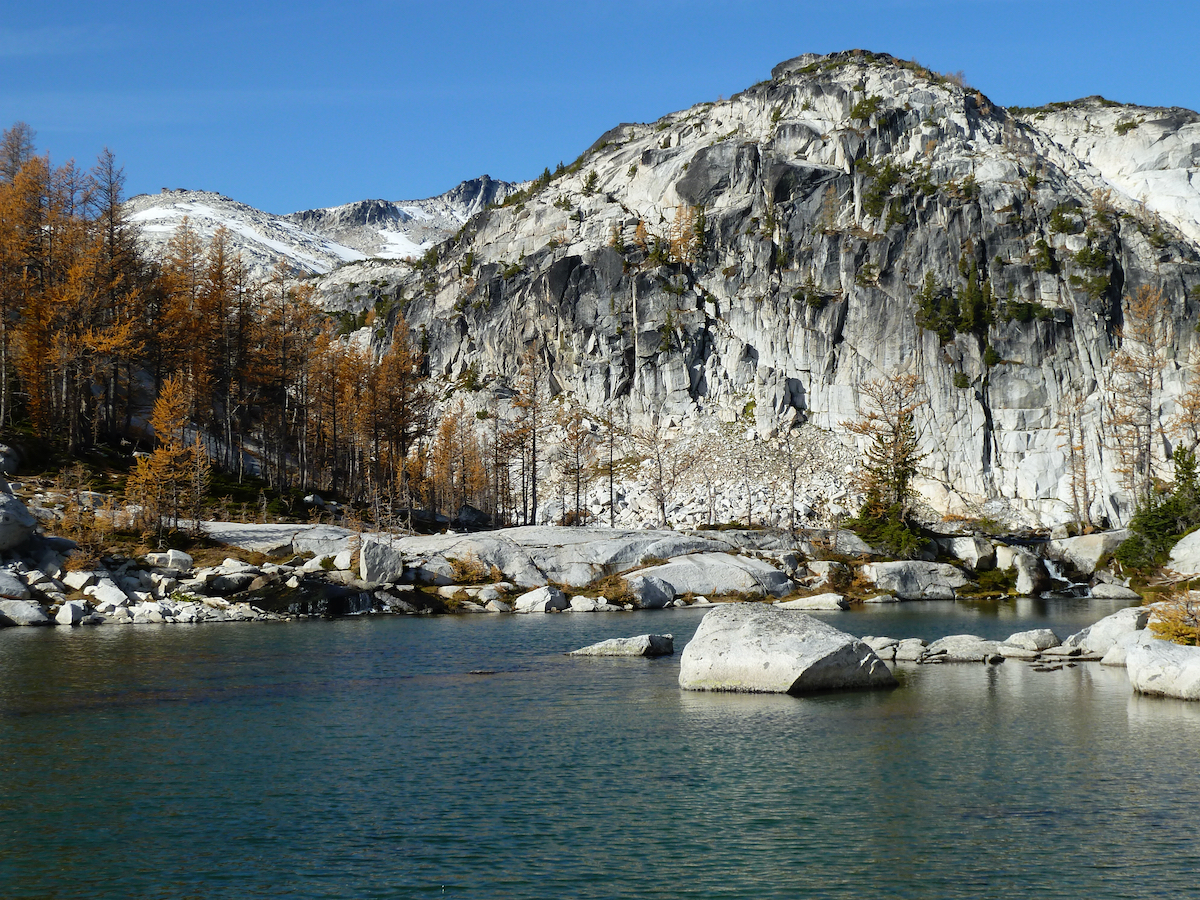 lake with rock mountain wall in back