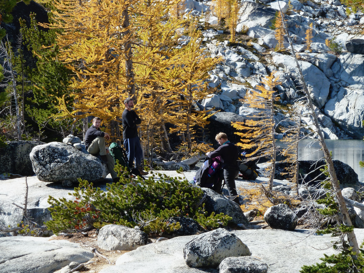 guys hanging out beside lake