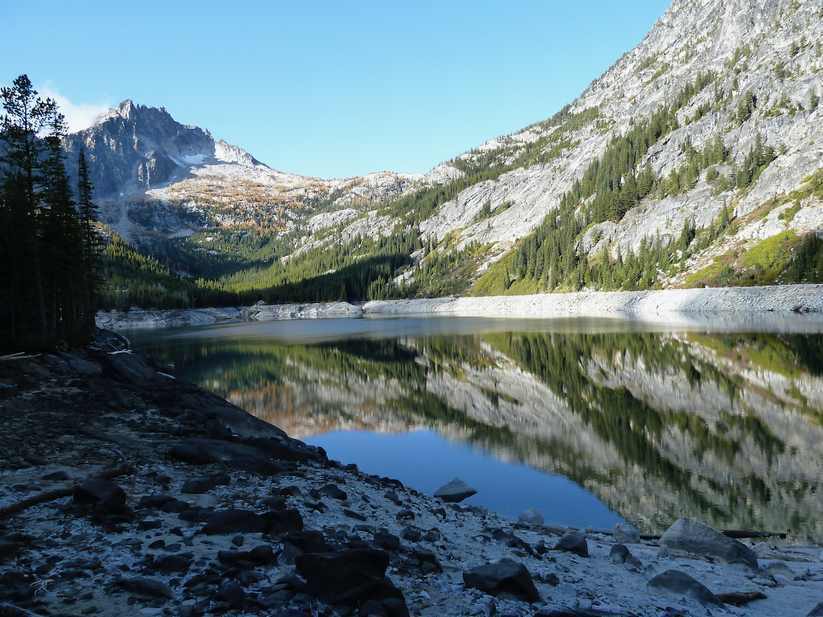 lake with low water and reflections of mountains