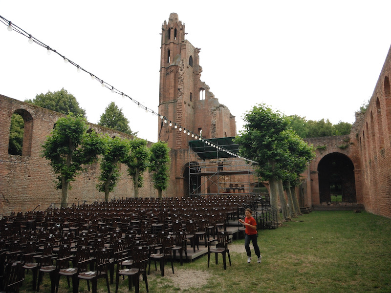 Grassy area with brick walls around and chairs