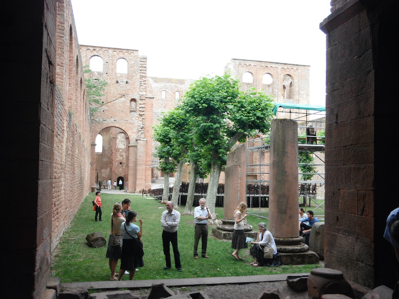 Trees, ruined columns, walls around grass