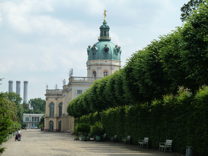 Castle building on grounds beyond trees