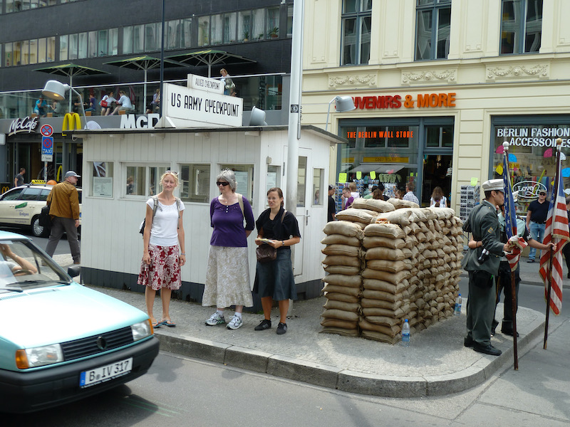 Guard building and sandbags on island in car traffic