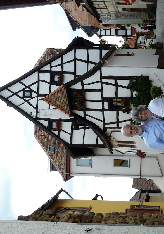 Standing together in front of traditional-style house