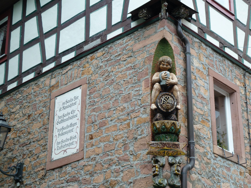 Corner of a building with inset statue holding a stein