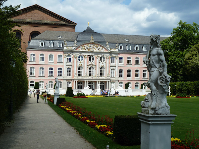 Pink royal-like building with gardens in front