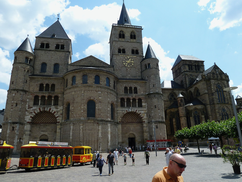 Two large stone churches beside plaza