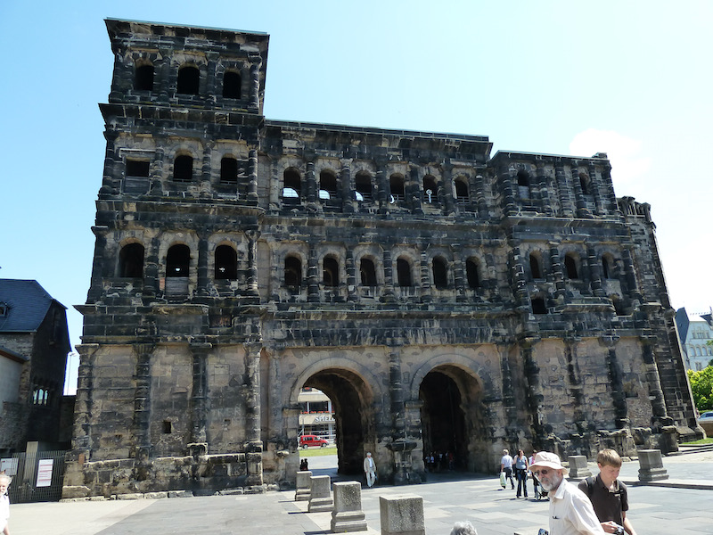 Squared three story gate of blackened stones