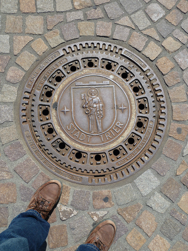 Manhole with crest of Trier