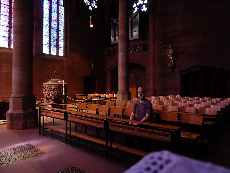 Sitting, style very different from the church