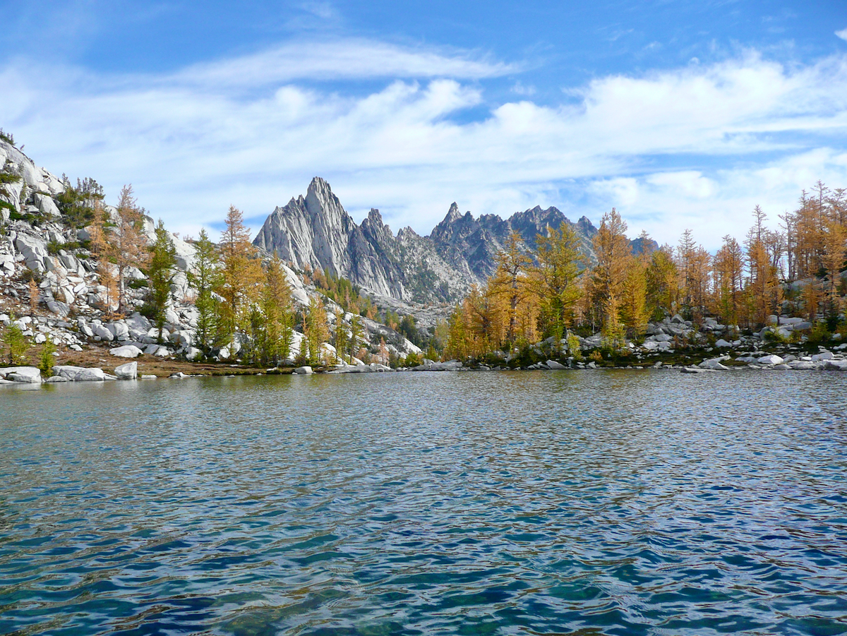 view across lake with trees and mountain ridge beyond