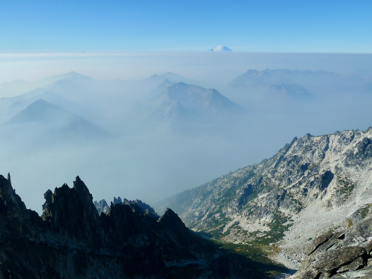 horizon of smoke with Rainier above in distance