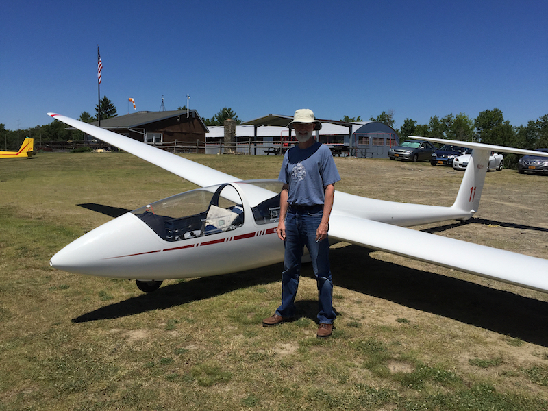 Larry standing by parked glider