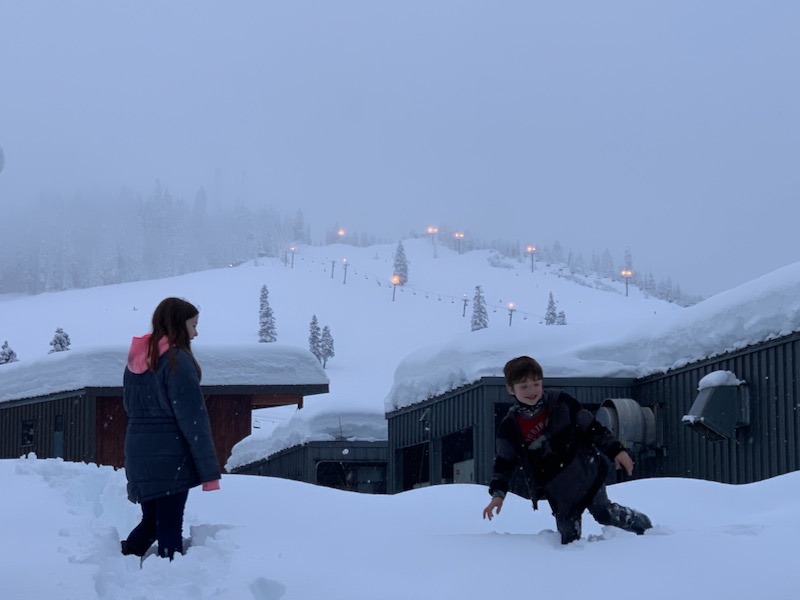 kids climbing on snowpiles