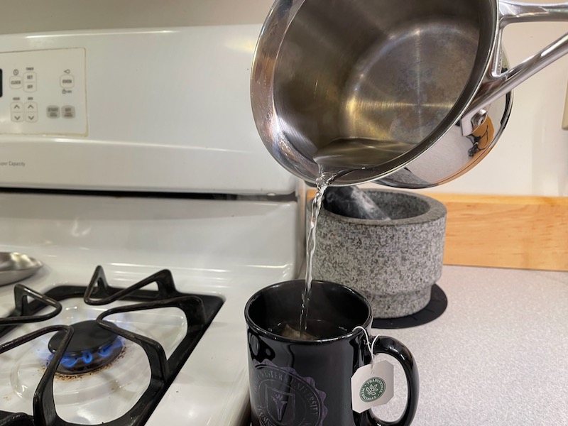 boiled water being poured into tea mug