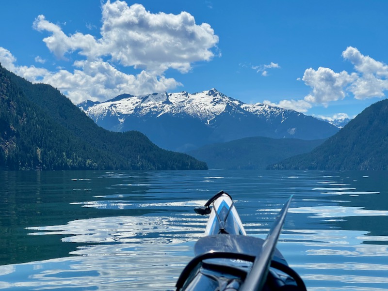 View of calm lake and mountains from boat