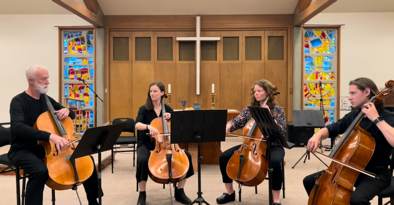 Four cellists at start of performance