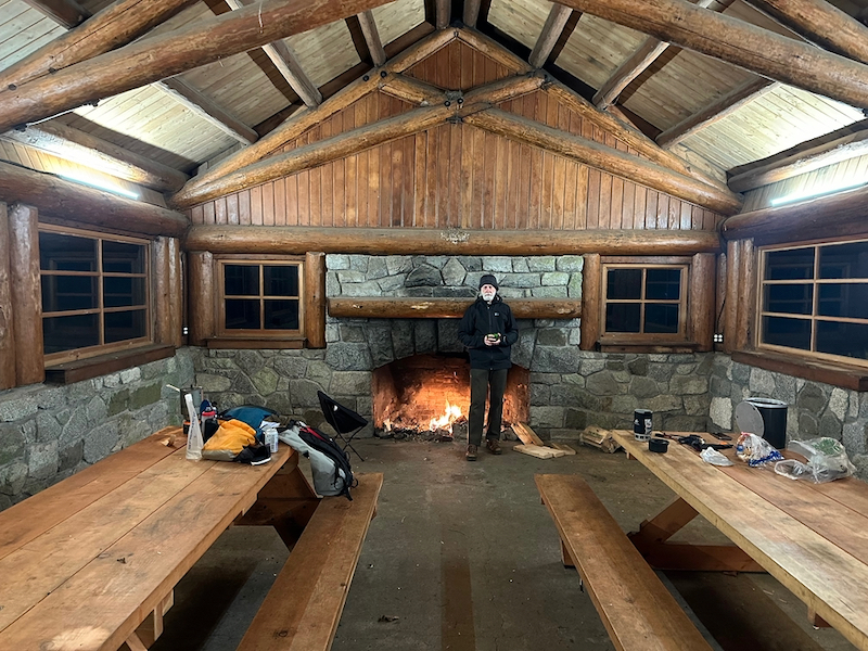 inside shelter with fire and camping dinner supplies