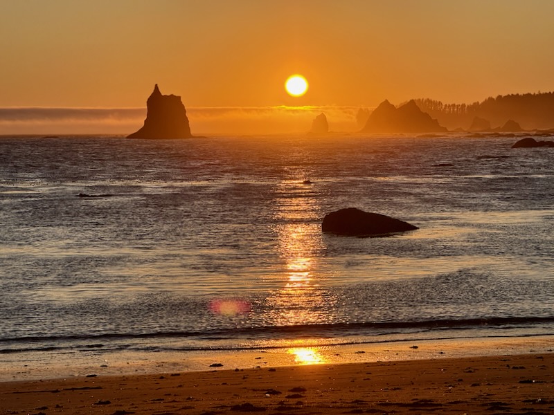 islands, sunset and light trail on water