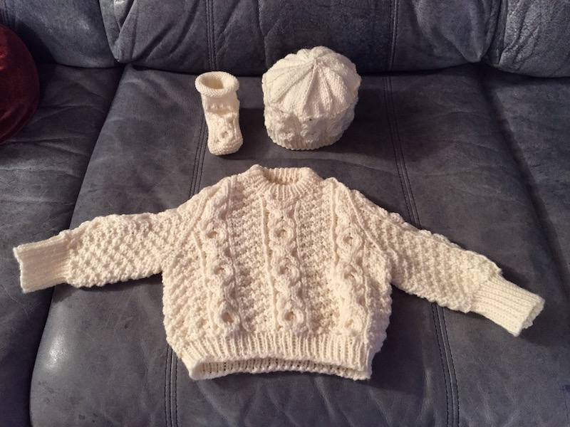 White baby sweater, hat and bootie