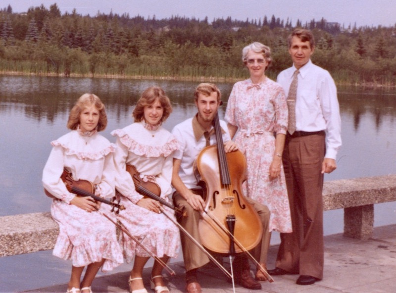 Grove family portrait by a lake with instruments