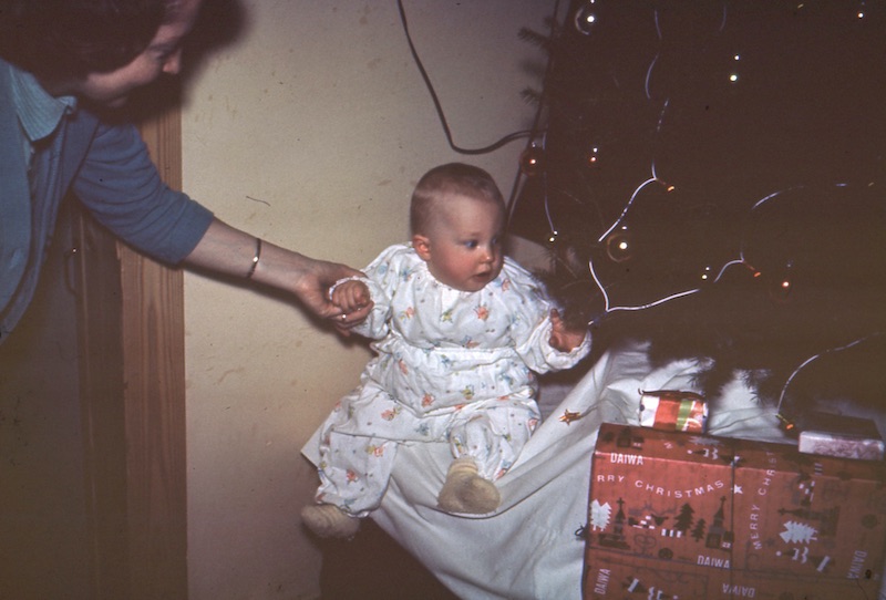 Baby Larry looking at Christmas tree lights