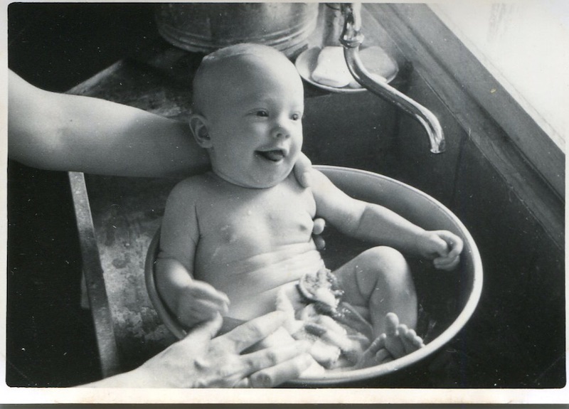 Larry being bathed in a basin