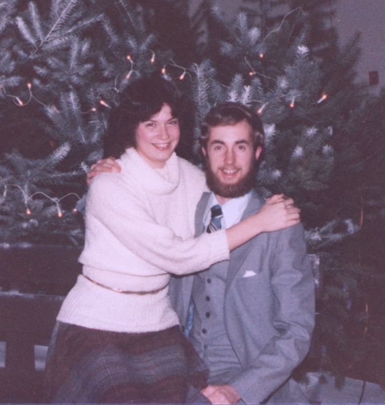 Larry and Melanie in front of a school Christmas tree